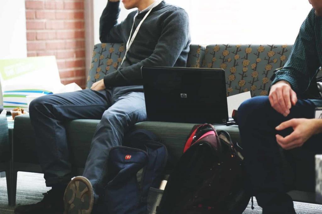 Two people sitting with laptop