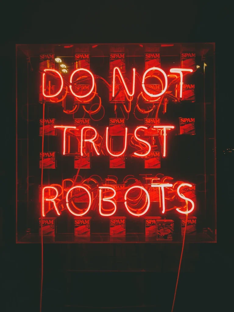 A bright neon sign in red letters reads "DO NOT TRUST ROBOTS" against a dark background. Behind the sign are several cans of SPAM, adding a quirky element to the scene.